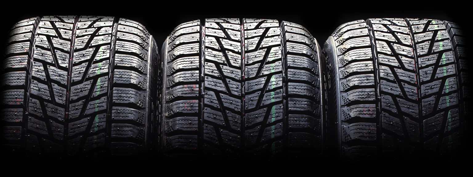 Three stacked winter tires close-up.